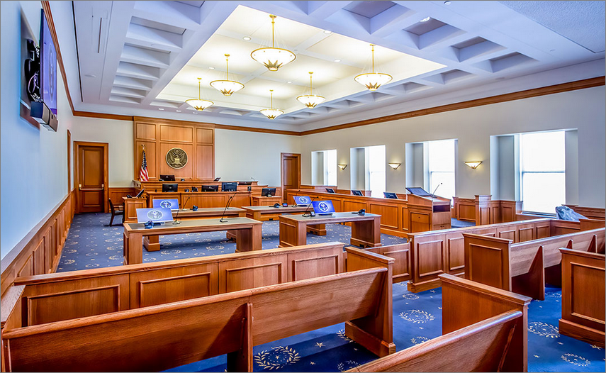 A photo of a courtroom, blue lighting.